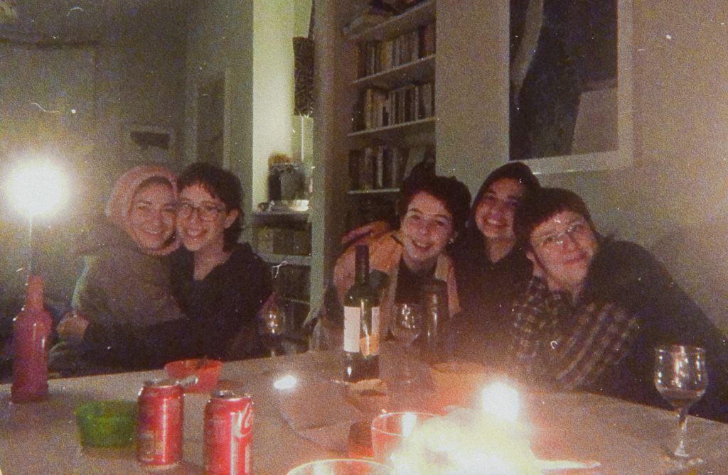 five people cuddling around the shabbas dinner table